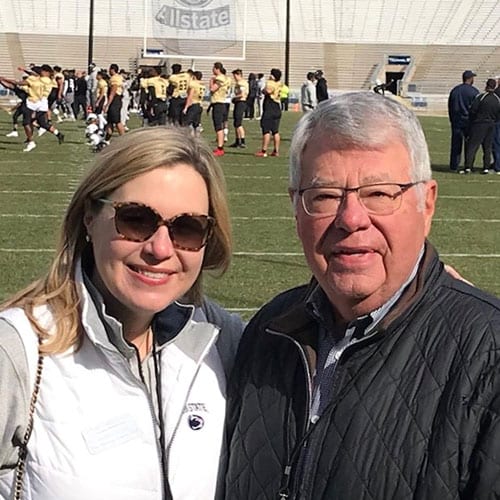 Roger and Jennifer Moyer standing on the field of Beaver Stadium.