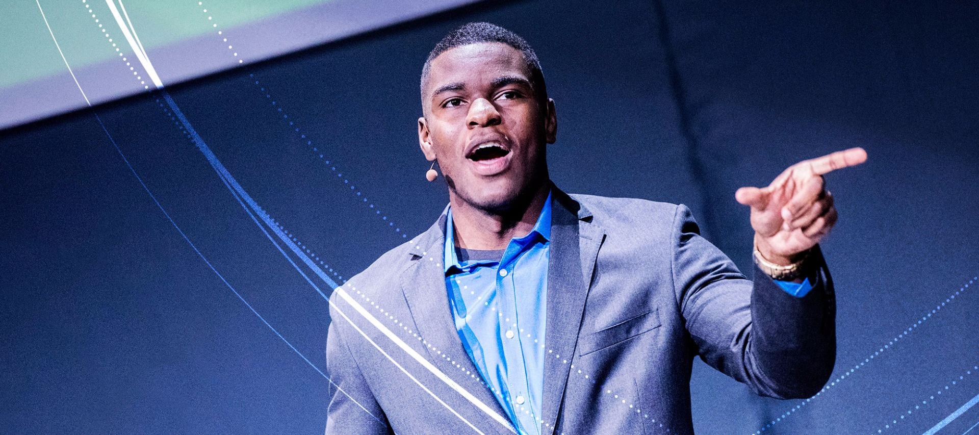 Penn State student, Jonathan Adrien, speaking on stage during Penn State’s Evening of Discovery event.